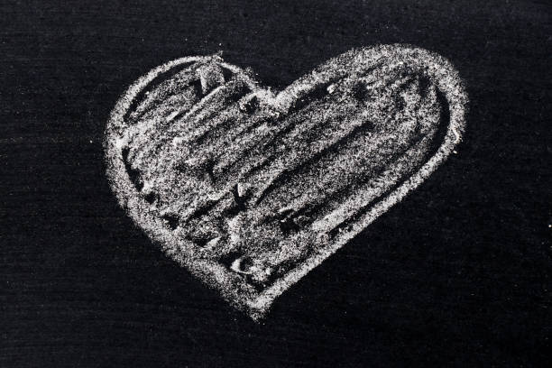 istock White chalk drawing in heart shape on black board background use for decoration in valentine, love, couple or engagement concept 819871132