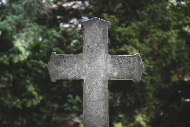 istock Stone cross gravestones on cemetery - graveyard 819878318