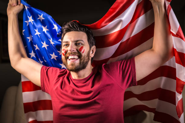 istock American fan holding the national flag 819897408