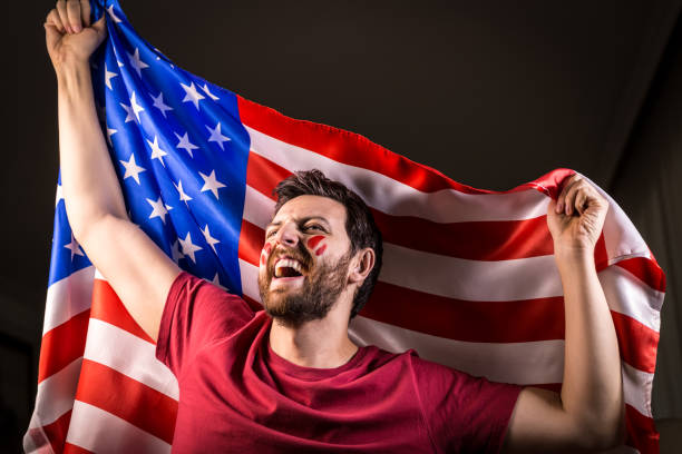 istock American fan holding the national flag 819897412