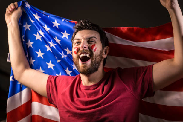 istock American fan holding the national flag 819897426
