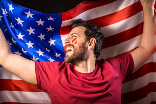 istock American fan holding the national flag 819897432