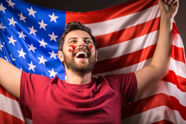 istock American fan holding the national flag 819897448