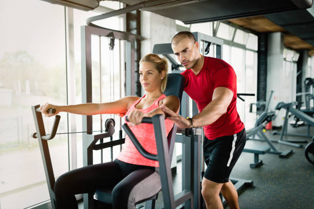 istock Beautiful girl working out with personal trainer 819897702