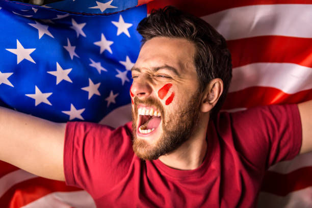 istock American fan holding the national flag 819898042