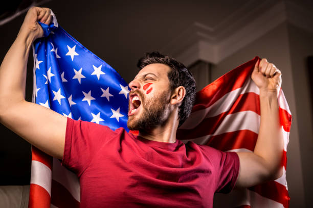 istock American fan holding the national flag 819898044