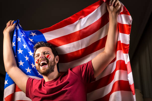istock American fan holding the national flag 819898050