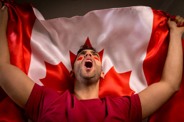 istock Canadian Guy Waving Canada Flag 819900150