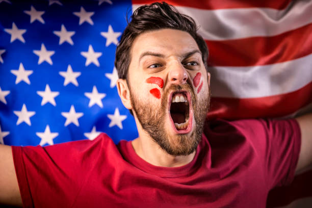 istock American fan holding the national flag 819900472