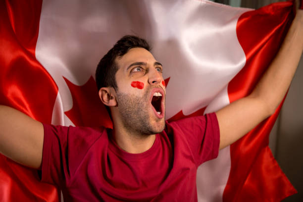 istock Canadian Guy Waving Canada Flag 819902198