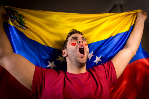 istock Venezuelan Guy Waving Venezuela Flag 819902230