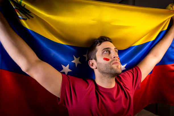 istock Venezuelan Guy Waving Venezuela Flag 819902232