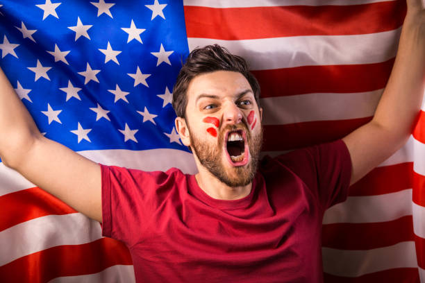 istock American fan holding the national flag 819902328