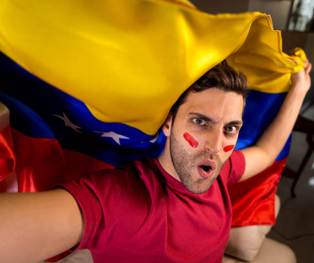 istock Venezuelan Guy Waving Venezuela Flag 819902368