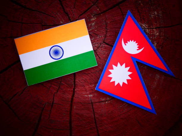 Indian flag with Nepali flag on a tree stump isolated stock photo