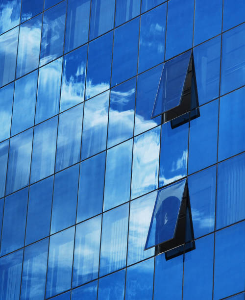 istock Reflection of clouds in a glass building 819905422