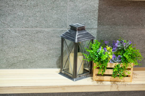istock Beautiful candle lantern with small tree in wooden basket 819907982