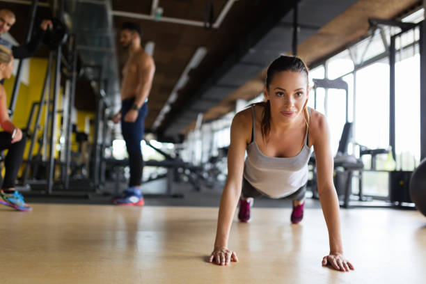 istock Young beautiful woman doing exercises in gym 819908046