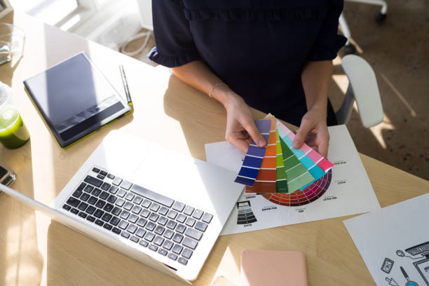 istock Female executives holding color shade swatch at her desk 819908414