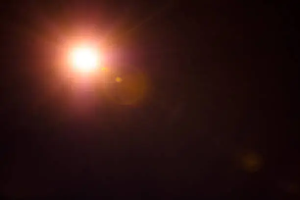 Photo of Photorealistic lens flare isolated on black background