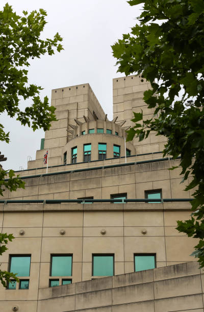 MI6 Building (Secret Intelligence Service), London - England A detail of the MI6 building shot through trees at 85 Albert Embankment, Vauxhall, Lambeth, London, England mi6 stock pictures, royalty-free photos & images