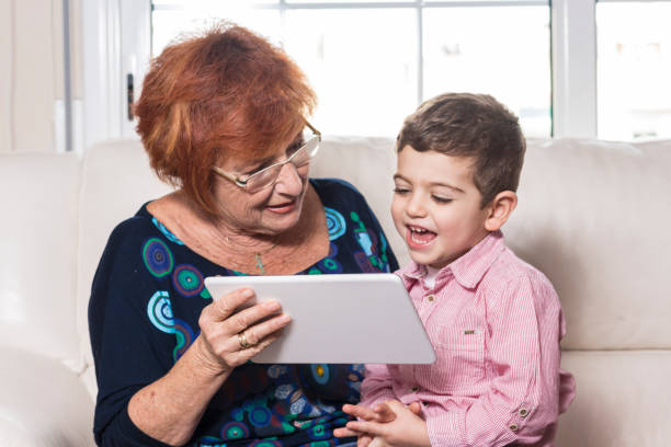 istock Grandmother with grandson playing on the tablet. 819937494