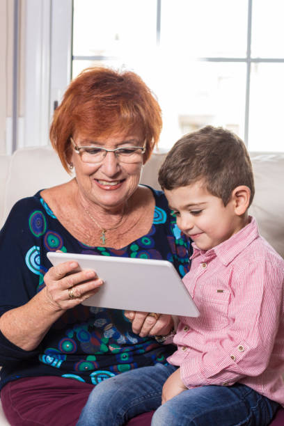 istock Grandmother with grandson playing on the tablet. 819937522
