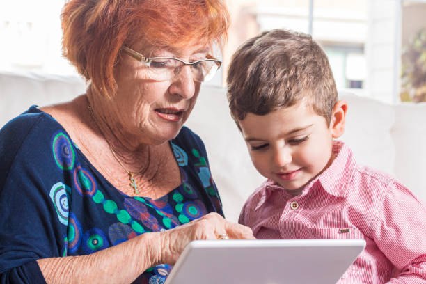istock Grandmother with grandson playing on the tablet. 819937548