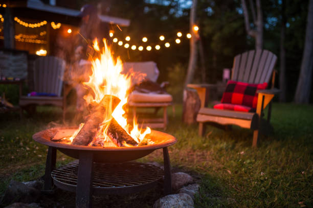 Late evening campfire at a beatiful canadian chalet Late evening campfire at a beatiful canadian chalet fire natural phenomenon photos stock pictures, royalty-free photos & images
