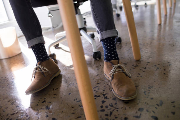 istock Male executive relaxing on chair in office 819953298
