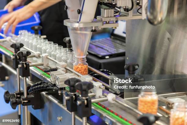 Tablet Capsule Counting Machine Conveyor In Production Line Of Pharmaceutical Industry Stock Photo - Download Image Now