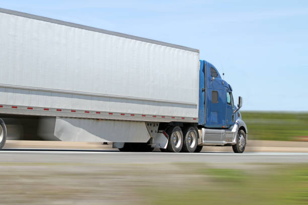 istock Semi Truck Travelling The Highway Delivering Its Load 819959408