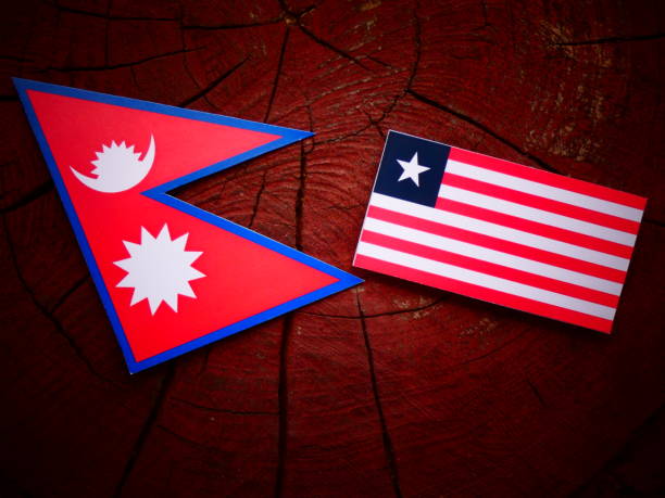istock Nepali flag with Liberian flag on a tree stump isolated 819963362