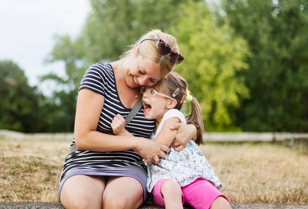 istock Mother and daughter hugging outdoors 819977436