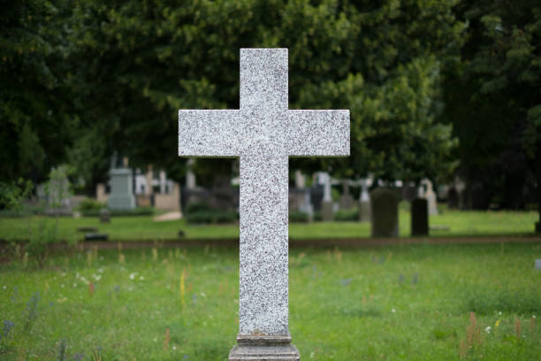 istock Stone cross gravestones on cemetery - graveyard 819996326