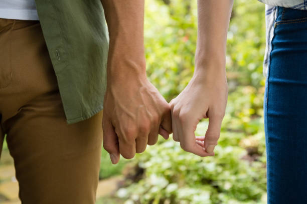 istock Mid-section of couple holding hands 820007330
