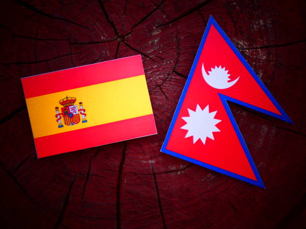 istock Spanish flag with Nepali flag on a tree stump isolated 820011886