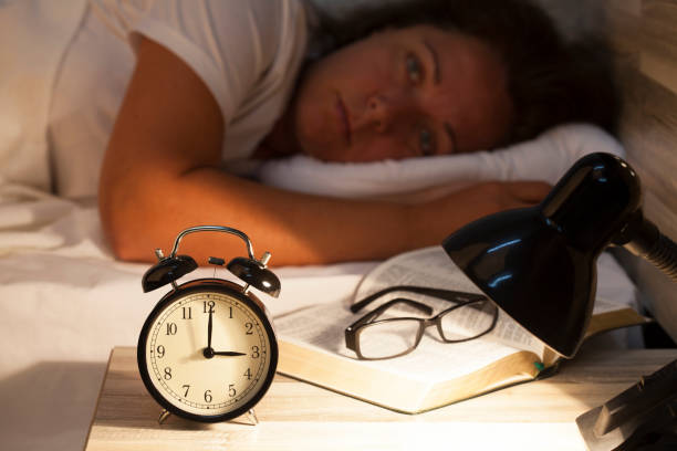 istock Woman lying in bed suffering from insomnia 820011918