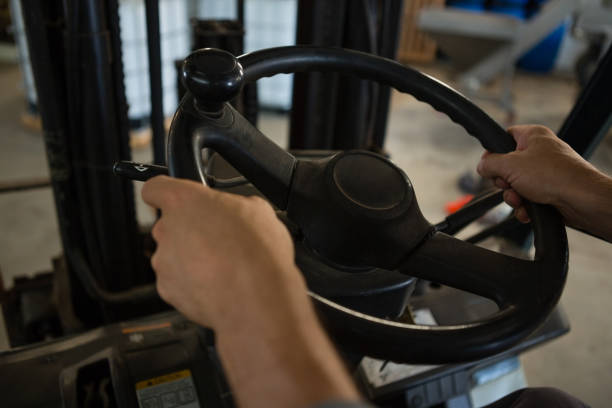 istock Mid-section of man driving a forklift car 820012384