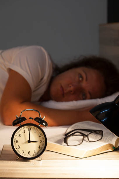 istock Woman lying in bed suffering from insomnia 820017726