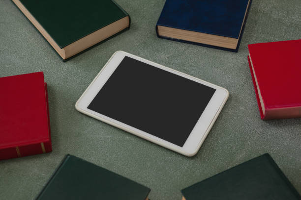 istock Digital tablet surrounded with colorful organizers on chalkboard 820018204