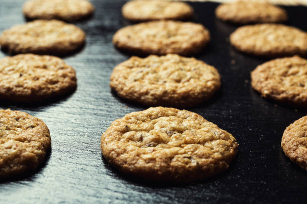 istock Biscuit sweet cookie background. Domestic stacked butter biscuit pattern concept,close up macro.Homemade cookies on wooden table.Cereal biscuits with the sesame,peanuts,sunflower and amaranth. 820018224