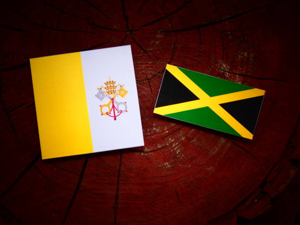 istock Vatican flag with Jamaican flag on a tree stump isolated 820040194