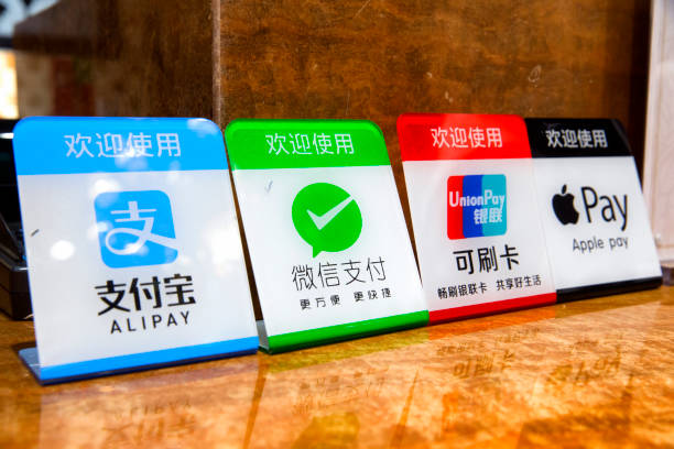 Mobile payment Shanghai, China - January 23rd, 2017 : Signs indicating the availalbe electronic payment methods in a store : alipay, Wechat pay, Western Union card, and Apple pay china unionpay stock pictures, royalty-free photos & images