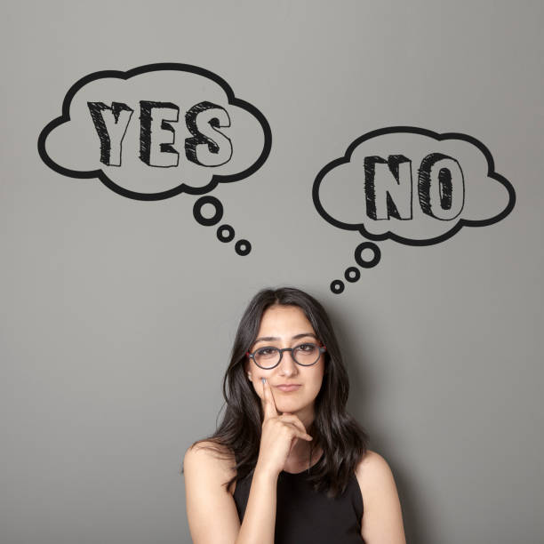 istock Young woman is trying to decide between yes or no. 820054496