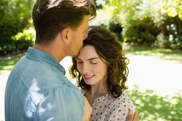 istock Man kissing woman on forehead 820054796