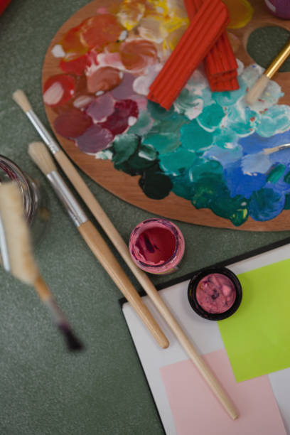 istock Watercolor paints and paintbrushes on chalkboard 820059530