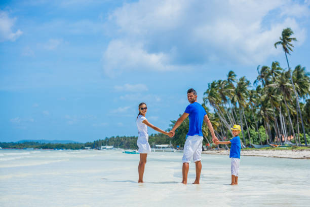 istock Father with two kids at tropical beach 820075448