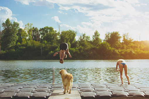 Jump into the river,woman,man and dog