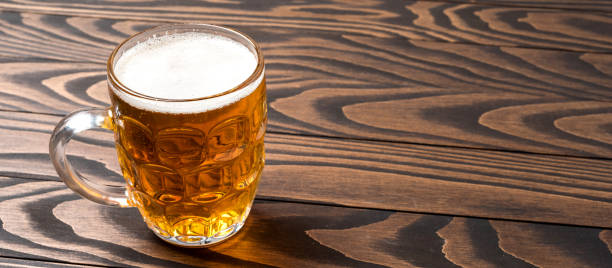 istock Mug of beer on an old wooden table 820092474